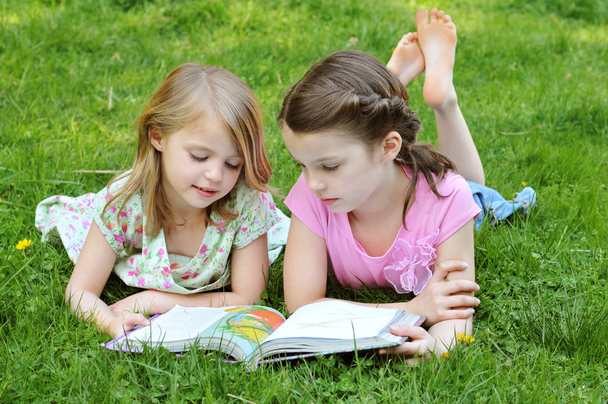 children reading outdoors
